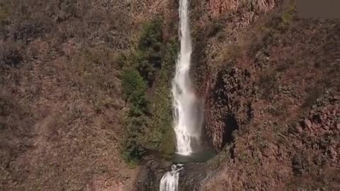 Aerial bird's eye view of cascade landscape scene shooting video