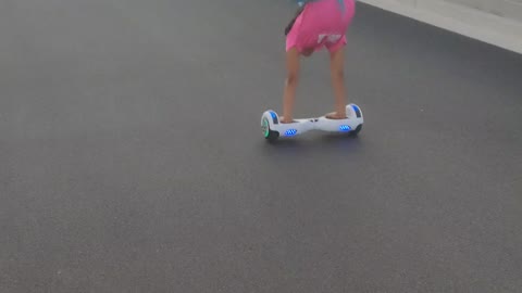 daughter balancing on hoverboard