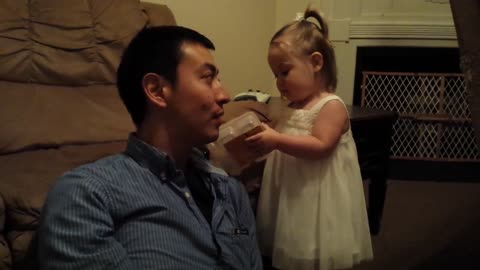 Toddler laughing at her hilarious Father