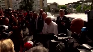 Pope Francis greets well-wishers as he leaves hospital