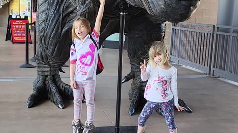 Kids pose next to T Rex