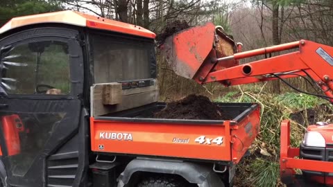 Daniel loading the RTV900 with the Kubota B7300