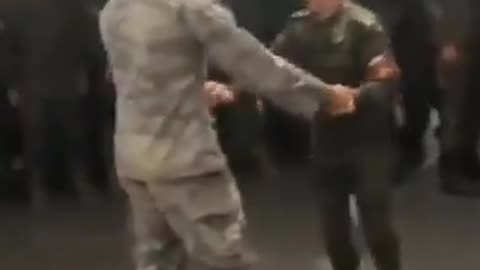 US & Russian troops dancing together in Niger