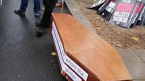 Man with coffin for the disabled and poor!