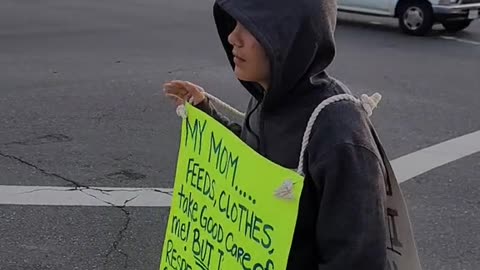 Son Made to Stand at Corner With Sign