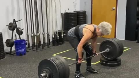 Elderly Woman Deadlifts Heavy Weights