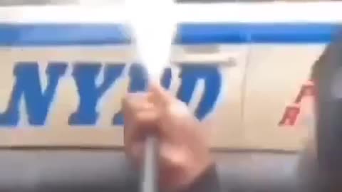 Group of individuals attack parked NYPD police car with officers inside