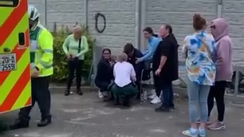 Elderly man being attended to by medical professionals after being attacked