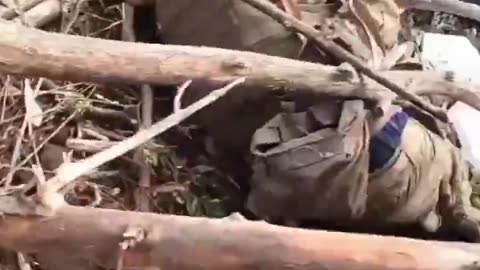 Ukrainian Soldier Searching a Russian Soldier