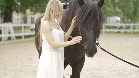 Milennial woman and horse at horse club