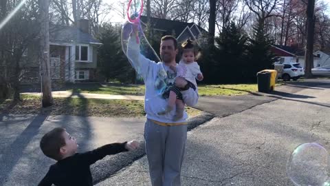 Baby girl gets super excited over daddy creating huge bubbles