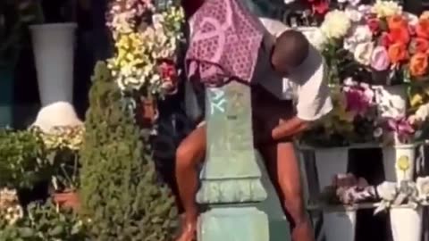 African in Italy cumming on a tombstone