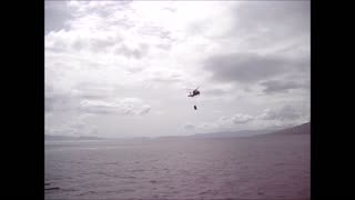 A pair of SH-60 Seahawks dropping supplies onto the flight deck