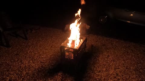 Lighting a campfire . Portable firepit.