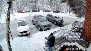 Tree Branch Comes Crashing Down While Man Shovels Snow