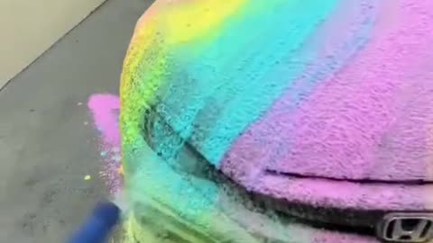 Before washing the car, spray colored foam.