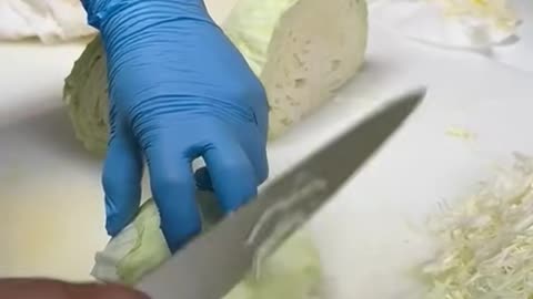 A woman cutting cabbage