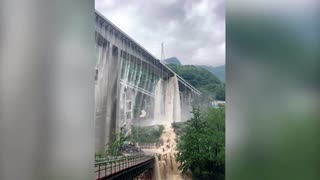 Water pours from bridges after heavy rain in China