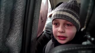 'We left our Dad in Kyiv' -little boy chokes back tears