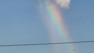 Rainbow Appears to Pour Out of Cloud