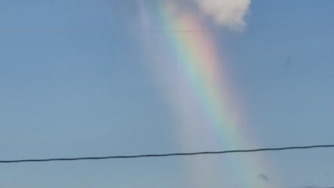 Rainbow Appears to Pour Out of Cloud