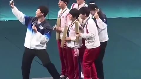 North and South Korean athletes take a selfie together at the Olympics