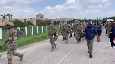 exas National Guard soldiers with riot gear heading to illegal crossing location near US-Mexico bord