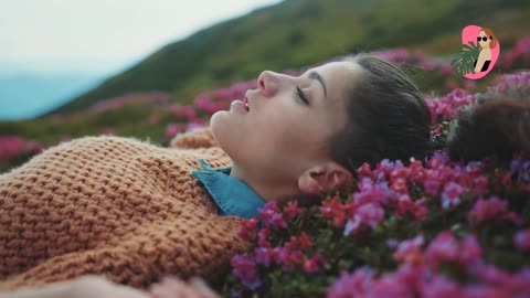 Young Girl Lying down in violet flowers - enjoying the Freshness moment