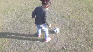 Little kid playing football.