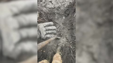 Fearless Ukrainian Female Soldier Digs Muddy Trench In The Rain During Russian Shelling