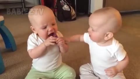 Funny twin baby girls fighting over pacifiers