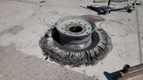 Crazy shredded tire. I wouldn't want to be in that vehicle when it happened.