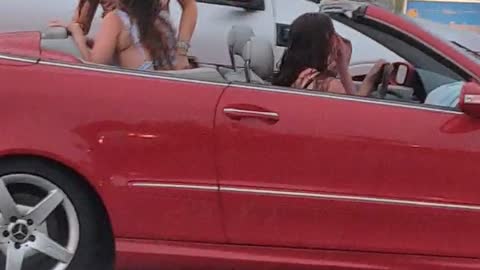 Girls Jam While Convertible Gets Soaked by Rainstorm