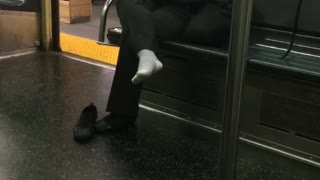 Well that sox woman wears white socks on train