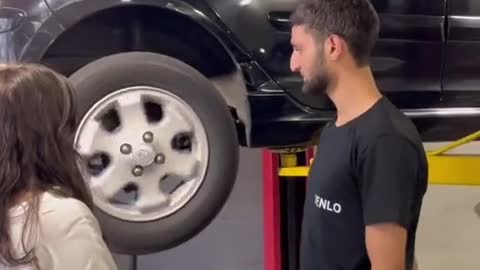 The repairman checks the condition of the tire