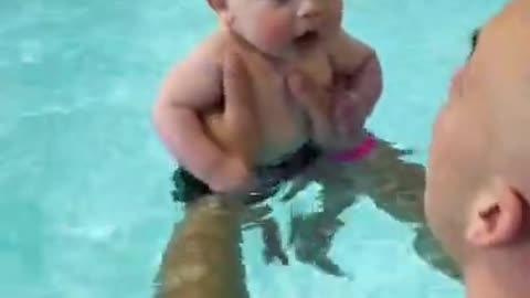 Cute baby swimming with dad 🐥