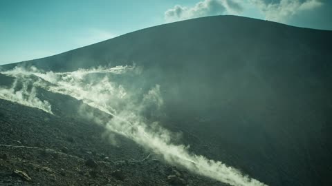 Rocky volcano while the smoke covers it