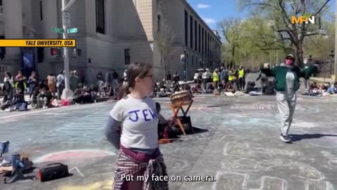 A woman seeks to provoke a negative response from student protestors