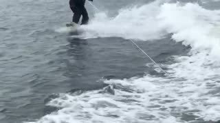 Guy water skiing in suit 2