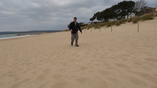 Walking towards the camera shot. On the beach