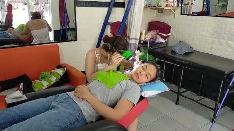 Relaxing earwax removal service with a beautiful girl at a Vietnamese barber shop