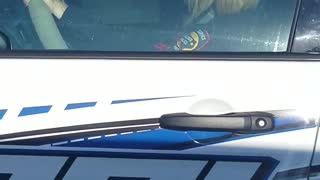 Officer Operates Phone Behind the Wheel