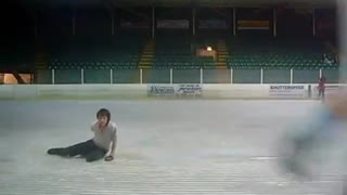 Figure skater slips and falls preparing for jump