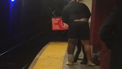 Guy takes off his pants in subway station