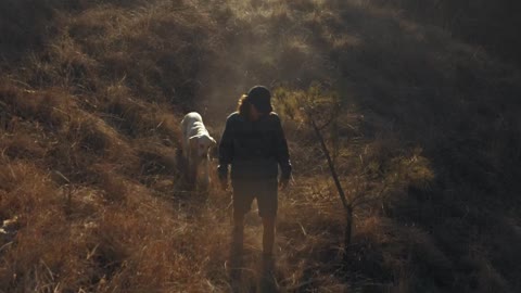 A man walking his dog in the morning