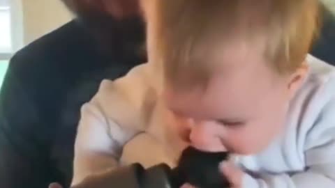 Cute baby eats a muscle hammer