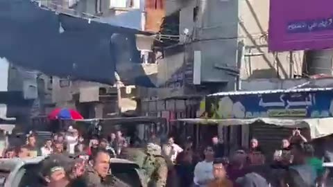 Palestinian Hamas terrorists parading the bodies of dead Israelis as crowds cheer