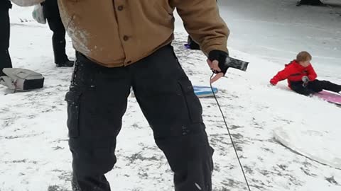 Music man boogie boards down snowy hill falls