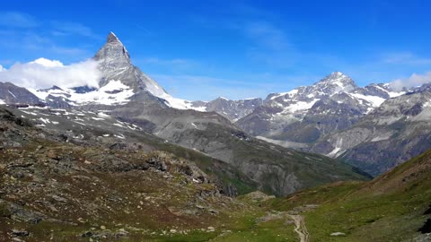 Mountain Ranges With Snow Under A Blue Sky