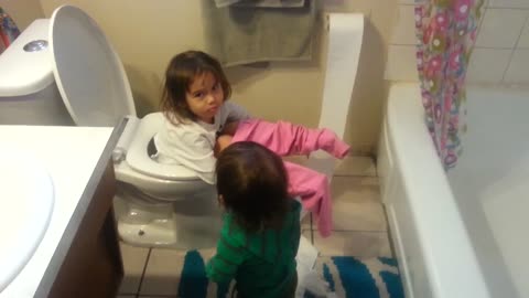 Girl falls in toilet while baby brother makes a mess with toilet paper